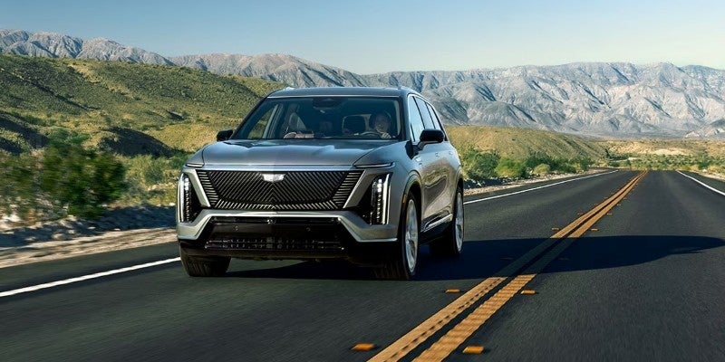 Cadillac SUV running Road