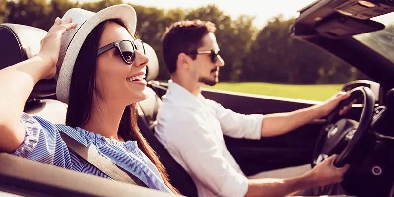 couple driving in their new convertible Fitzgerald Cadillac of Hagerstown in Hagerstown MD 