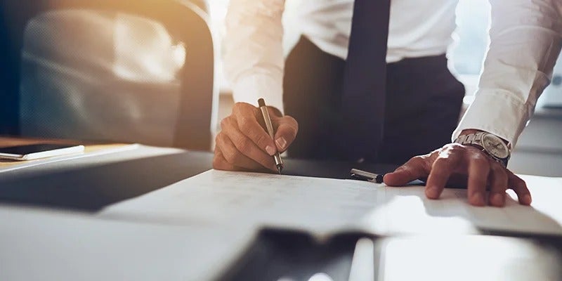 sales rep going over paperwork with customer from Fitzgerald Cadillac of Hagerstown in Hagerstown MD 